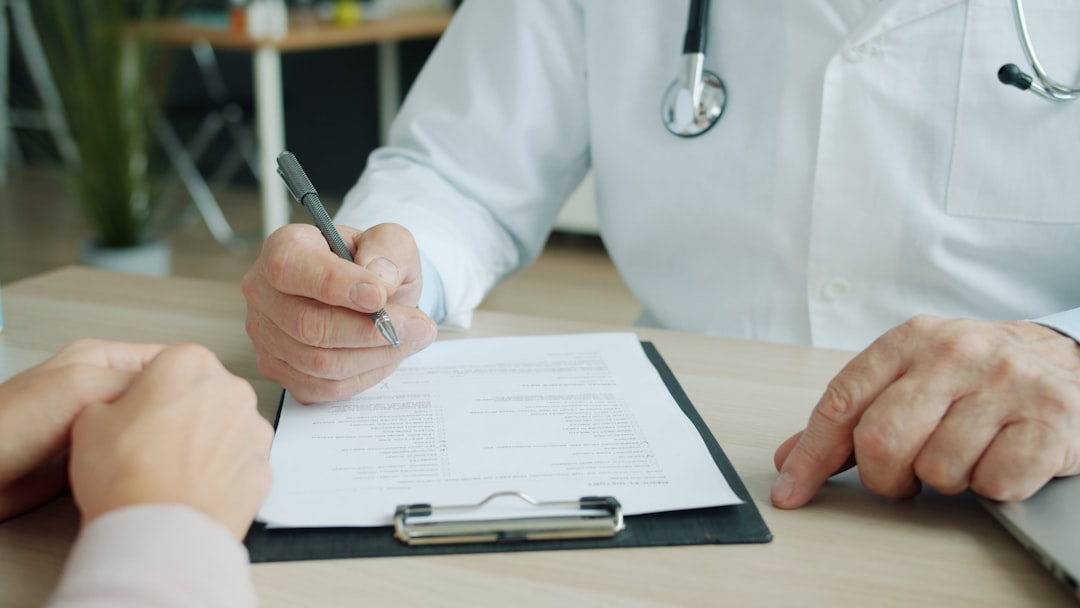 Medic in uniform is ticking symptoms in patients medical records during appointment in clinic talking to patient sick woman. People and healthcare concept.